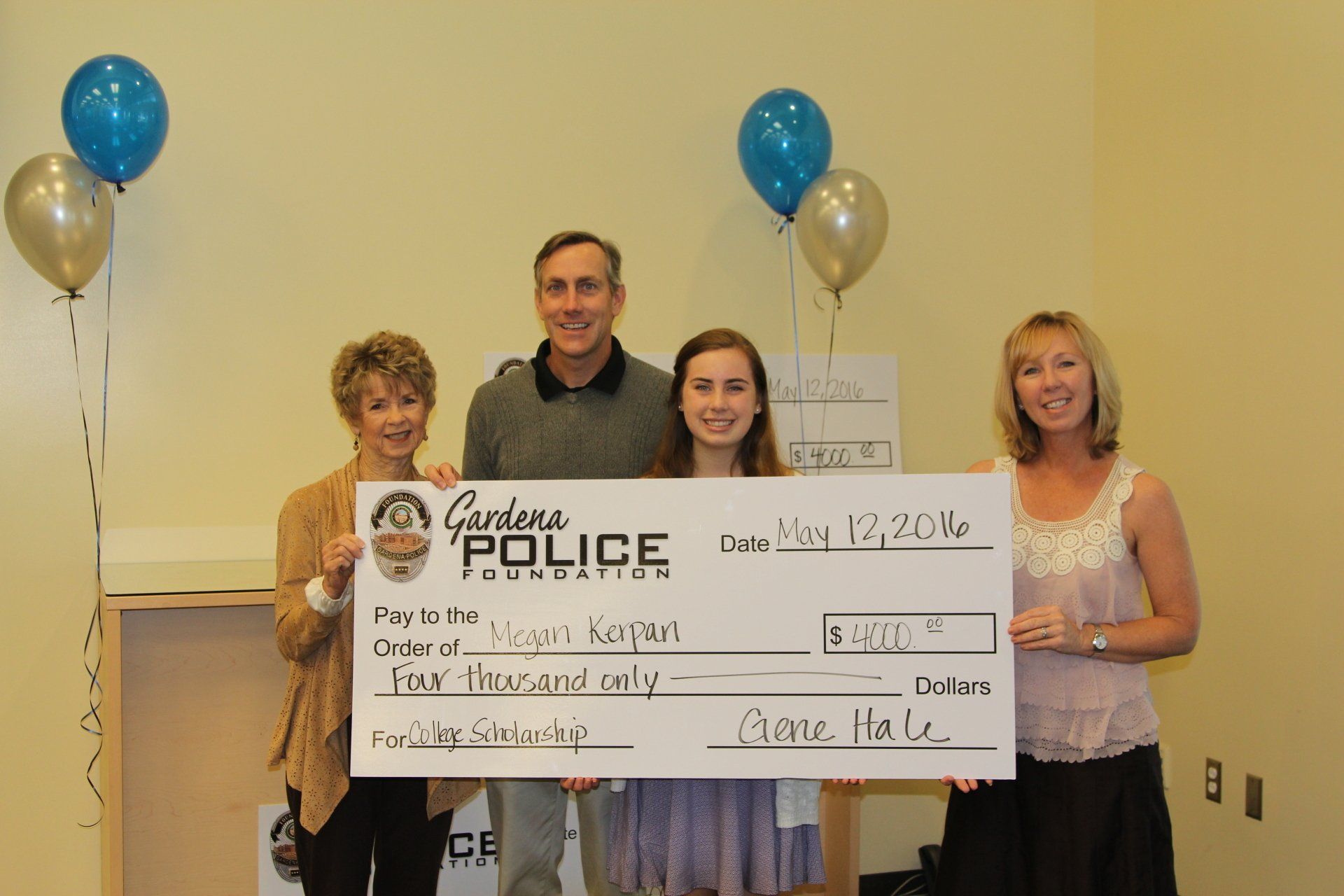 A group of people holding a check that says police on it