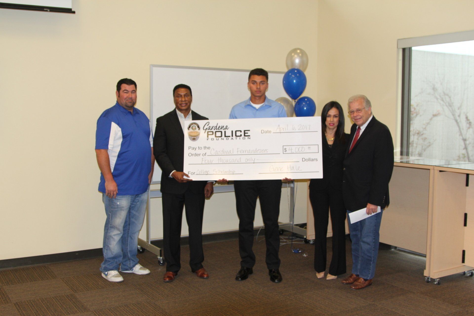 A group of people holding a large check that says police on it