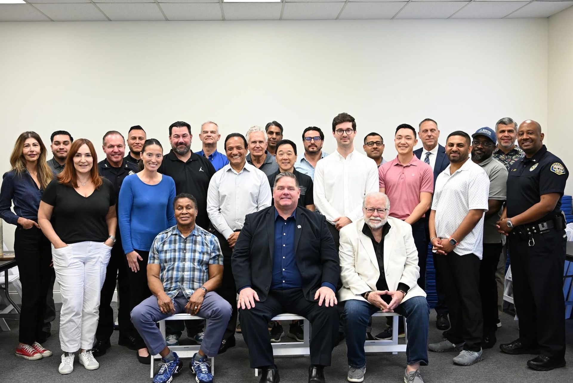 A group of people are posing for a picture in a room.