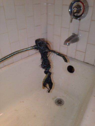 man snaking residential drain from hair-Drain Away Sewer Service, Inc. in Stamford, Connecticut