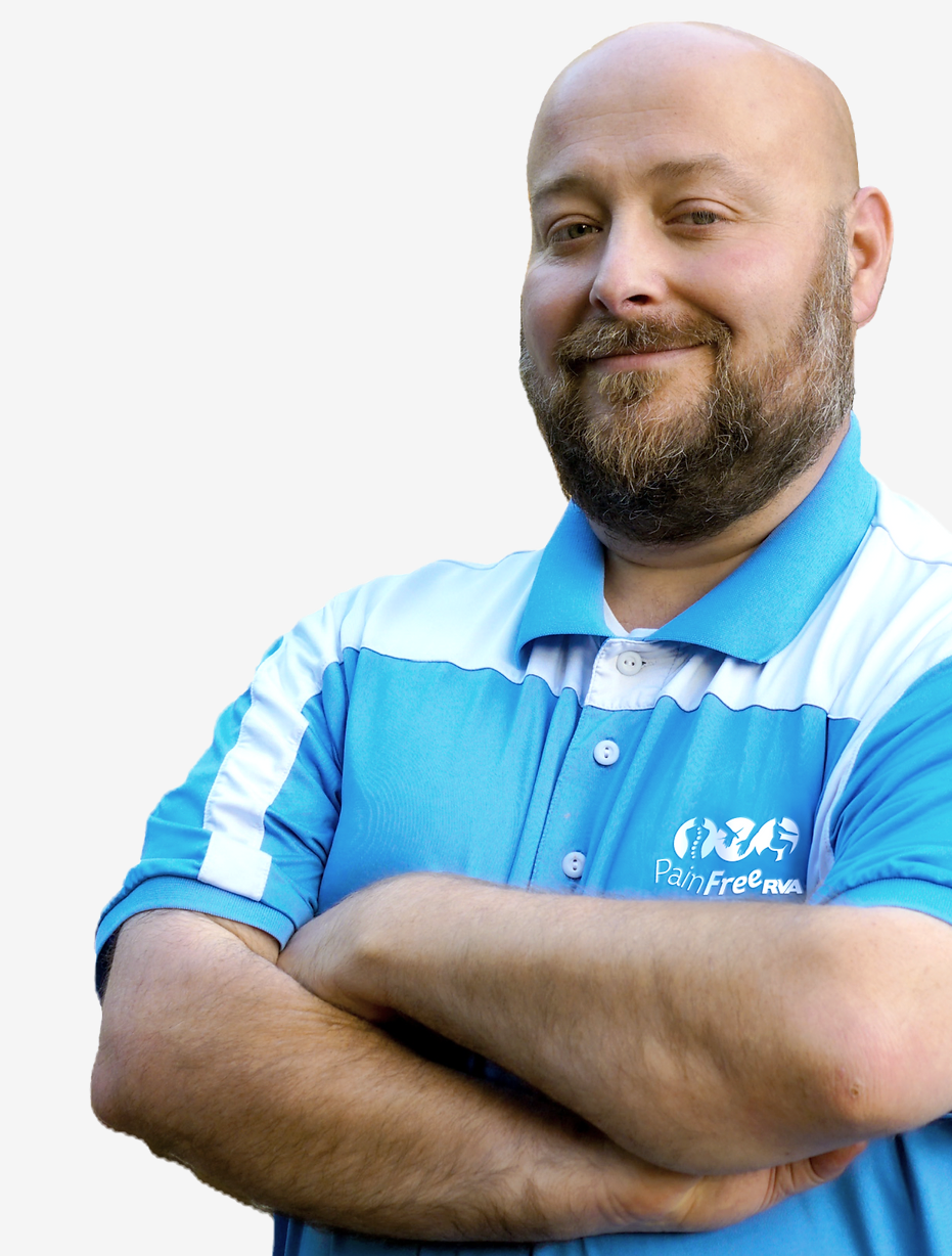 A bald man with a beard wearing a wellspring chiropractic shirt