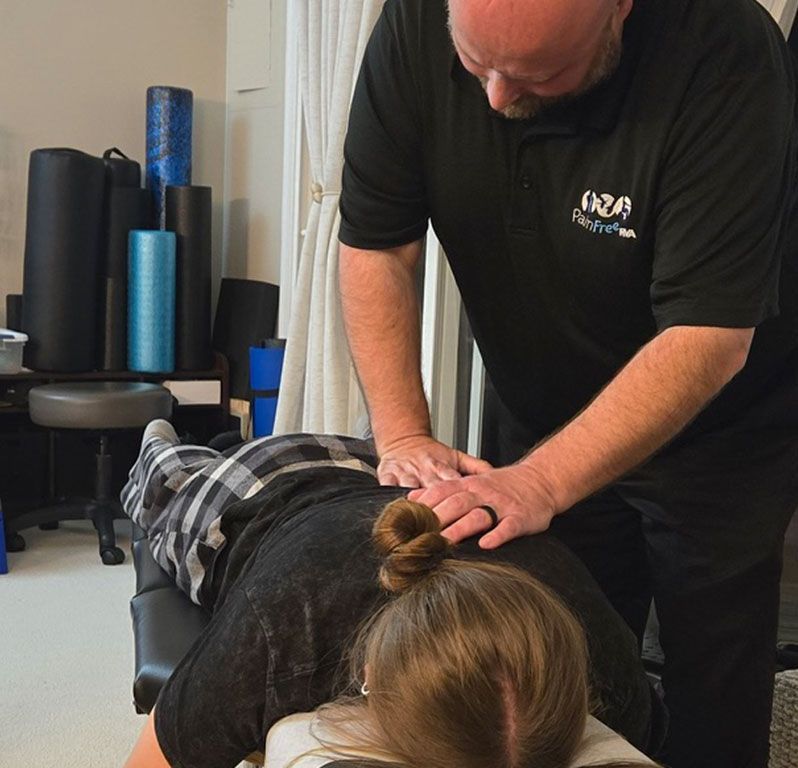 A doctor is examining a patient 's back in a hospital.