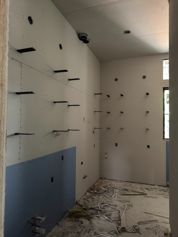 A room with a lot of shelves on the wall