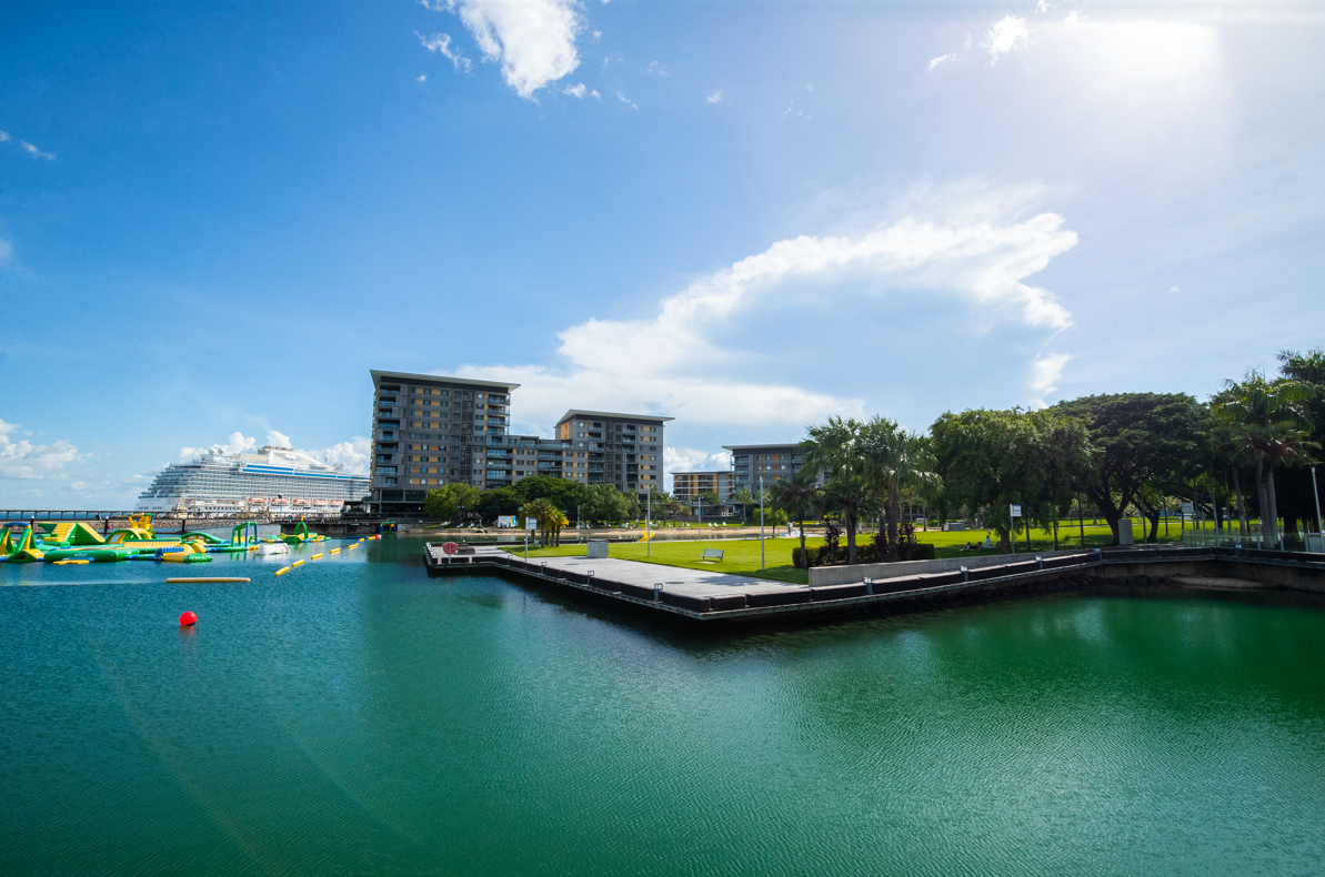 The water of the Recreation Lagoon is in the foreground and the background showcases the buildings and landscape of the Waterfront. 