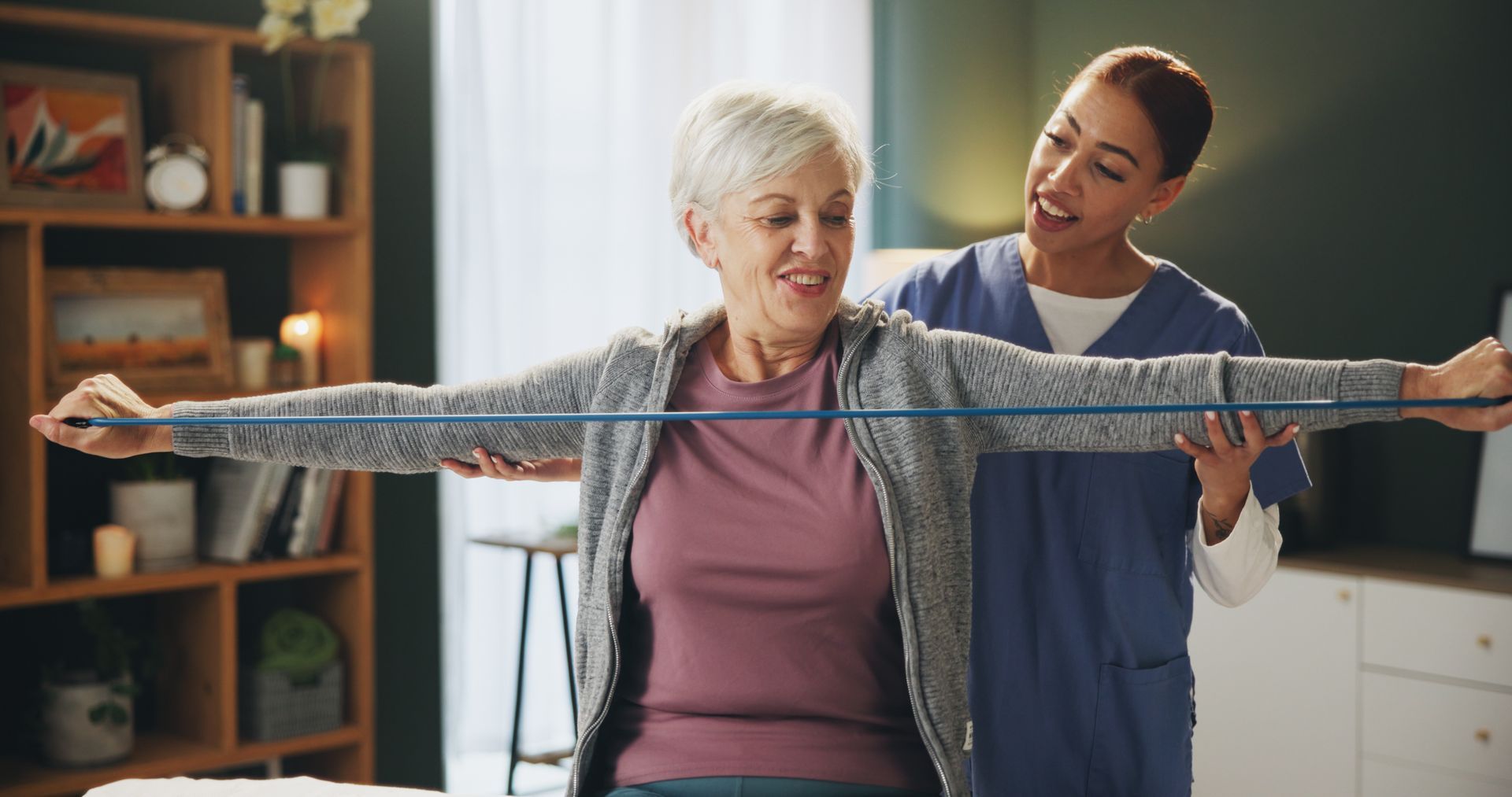 A nurse is measuring an older woman 's arms with a tape measure.