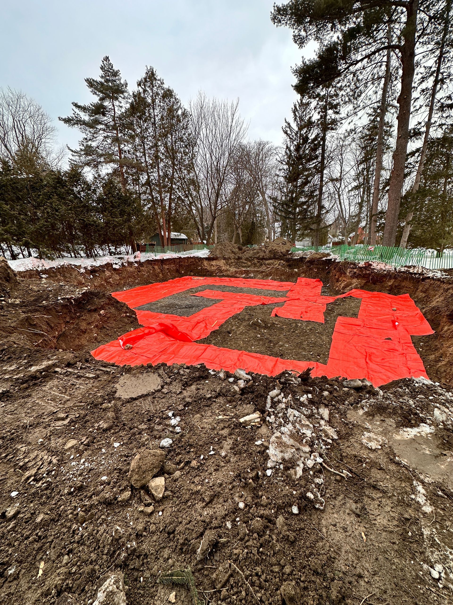 Un gros tas de terre recouvert d’une bâche rouge.