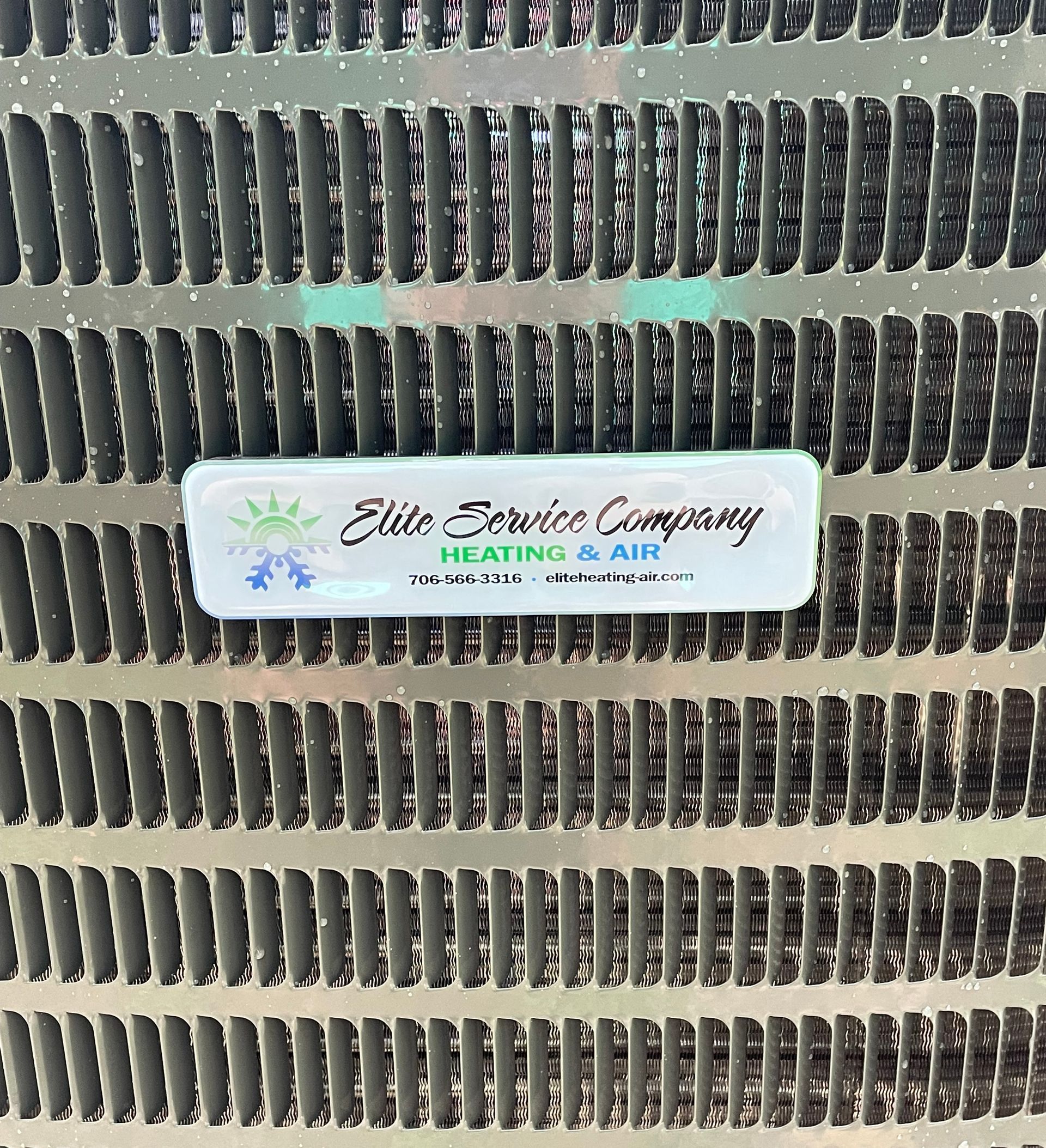 A close up of a radiator with a label on it that says elite service company.