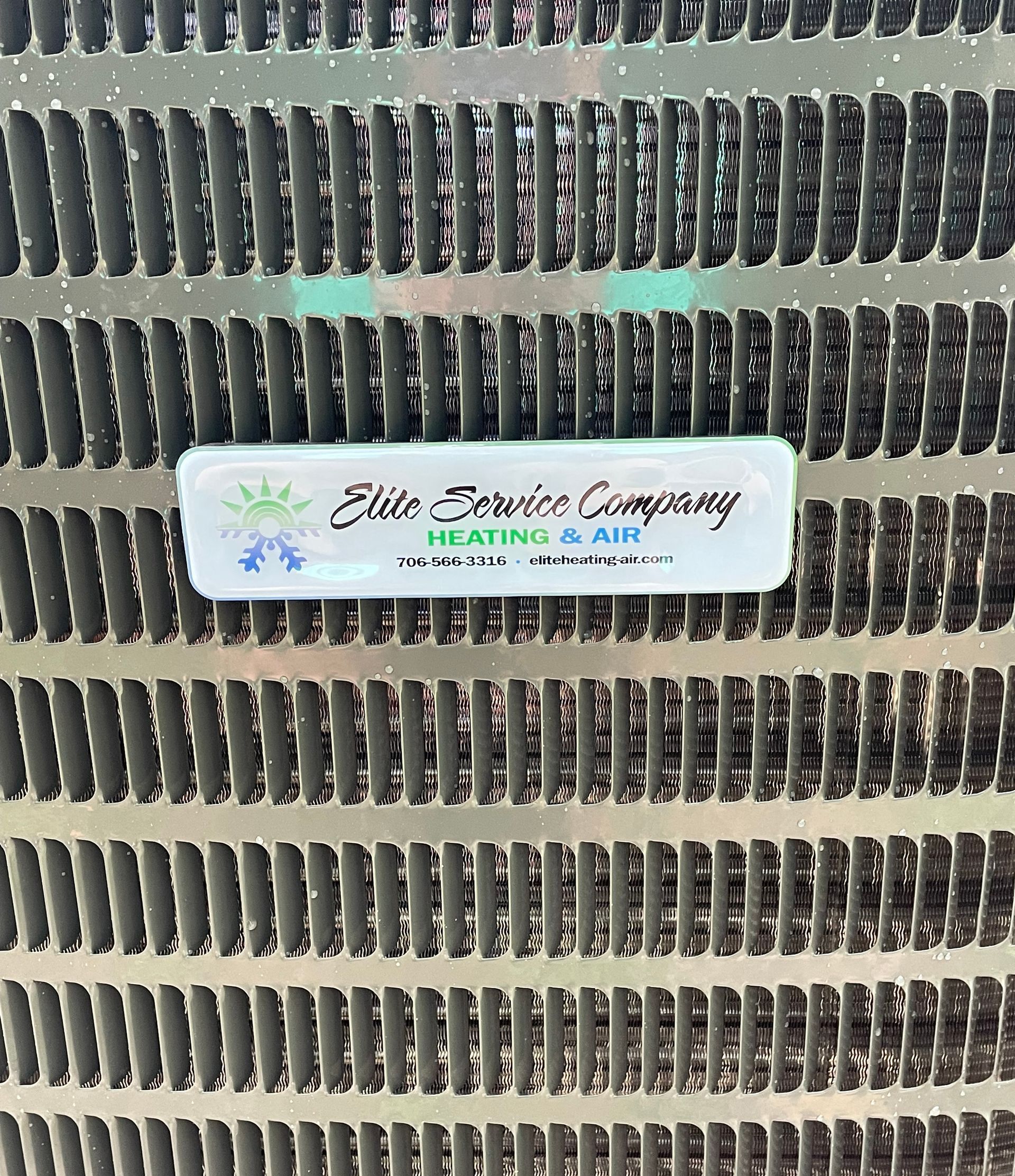 A close up of a metal grille with a label on it.