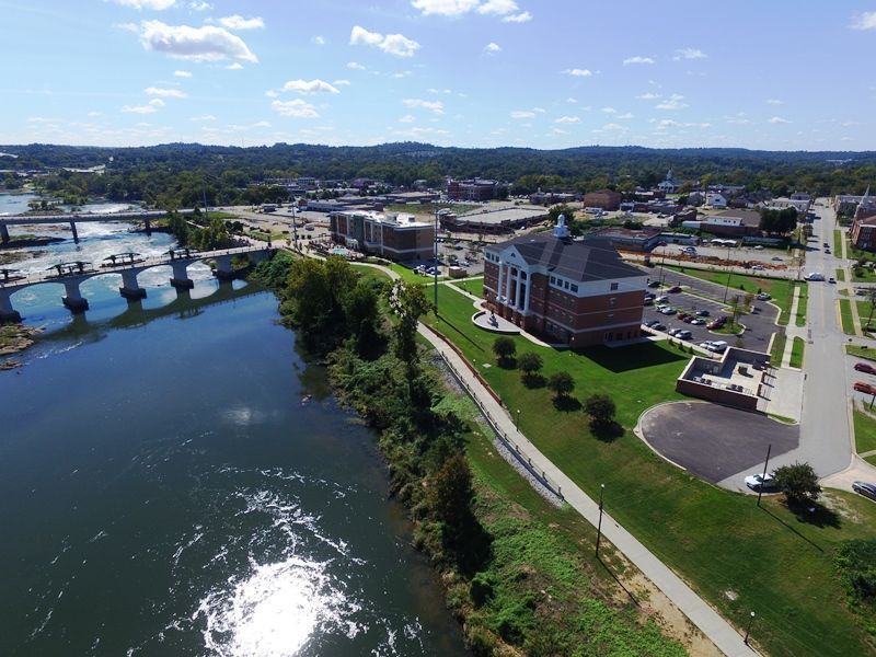 An aerial view of a city with a river and a bridge.