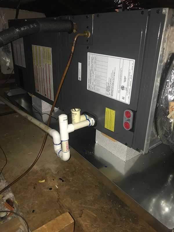 There is a pipe coming out of the back of a machine.