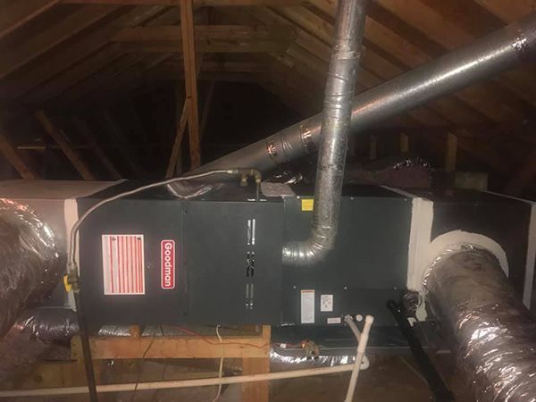 There is a ventilation system in the attic of a house.