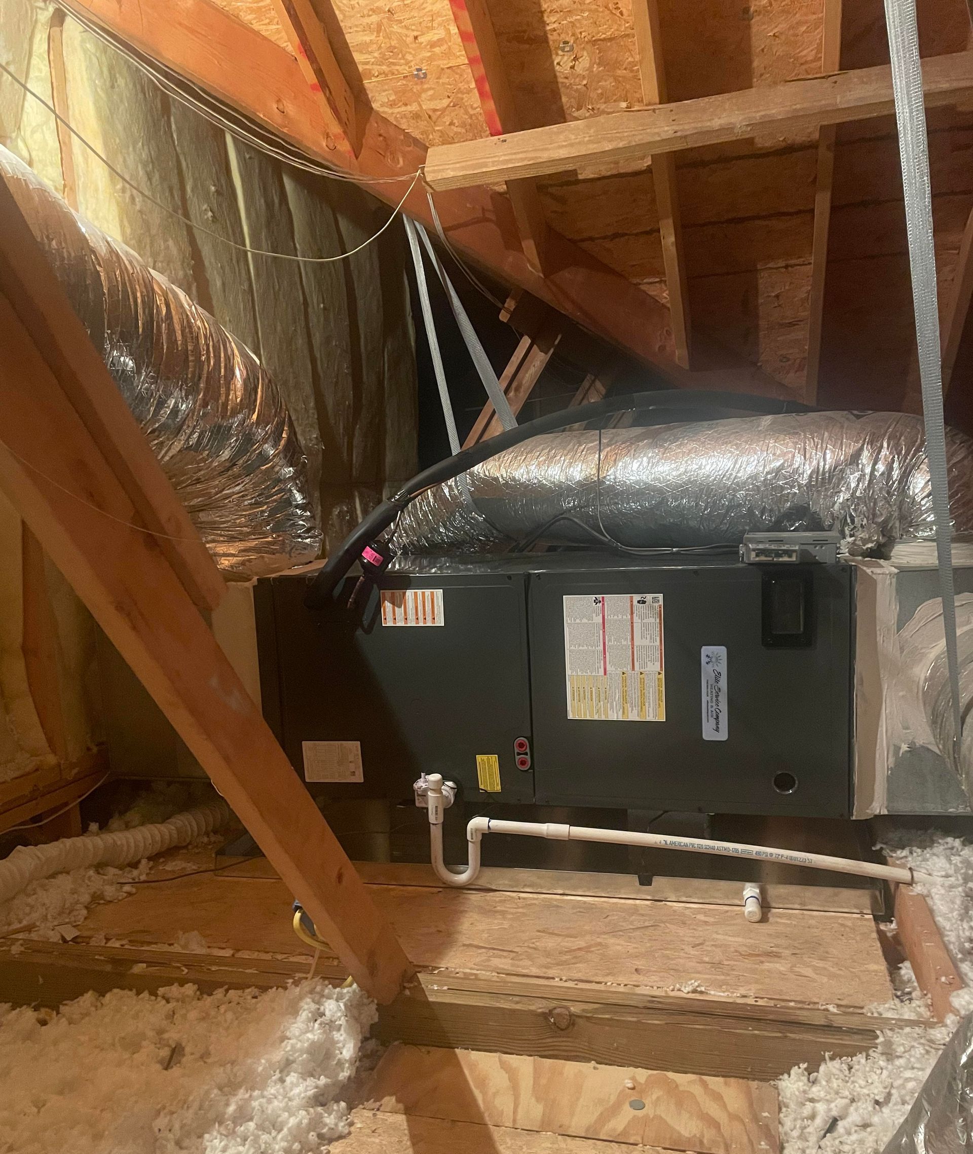 An air conditioner is installed in the attic of a house.