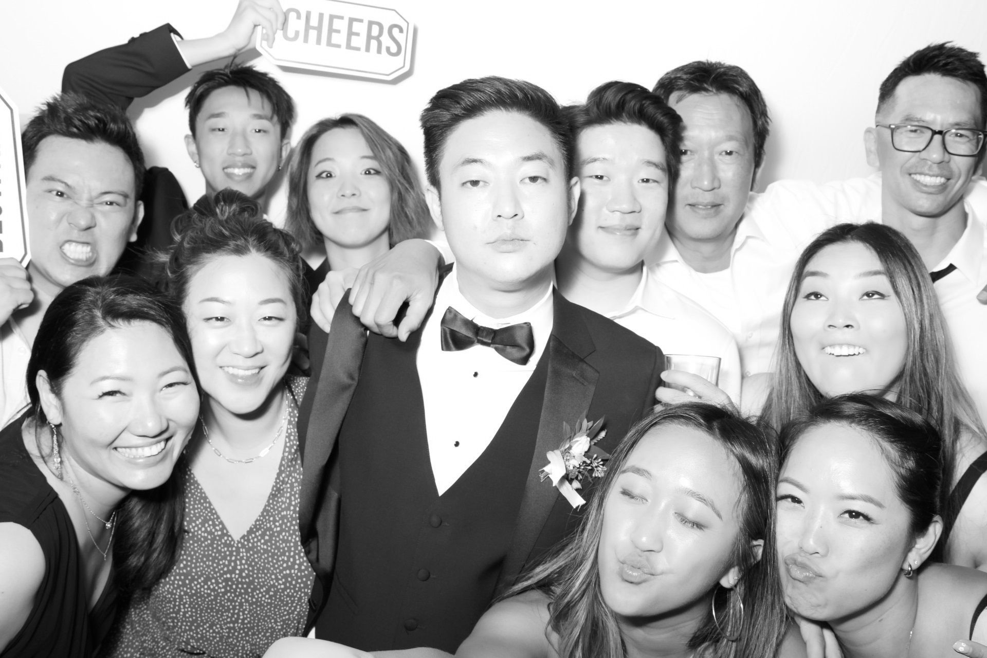 A group of people are posing for a picture in a photo booth.