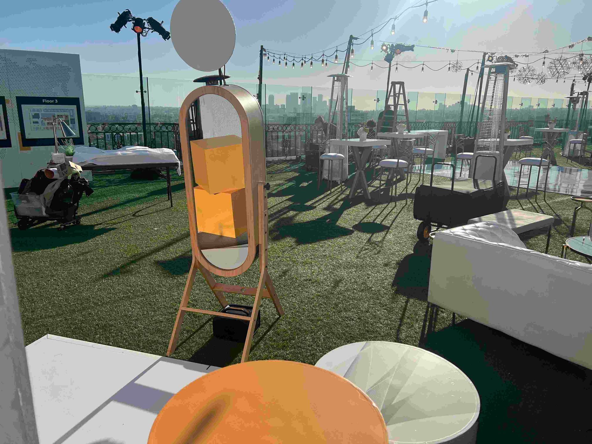 A photo booth is sitting on top of a lush green field.