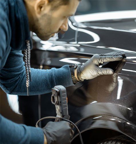 Worker Examining Vehicle Body — Rawlins, WY — Jacks Body Fender Repair