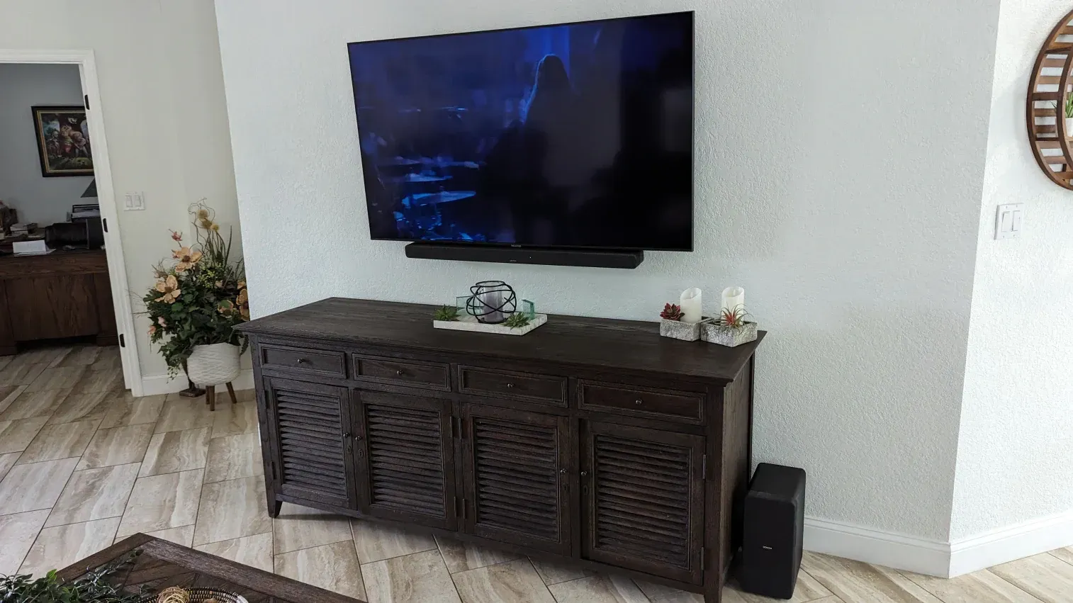 A living room with a large flat screen tv mounted to the wall.