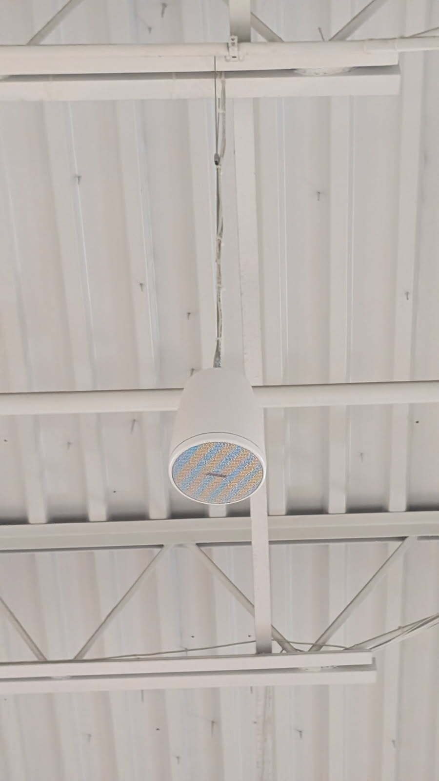 A ceiling fan is hanging from the ceiling of a building.