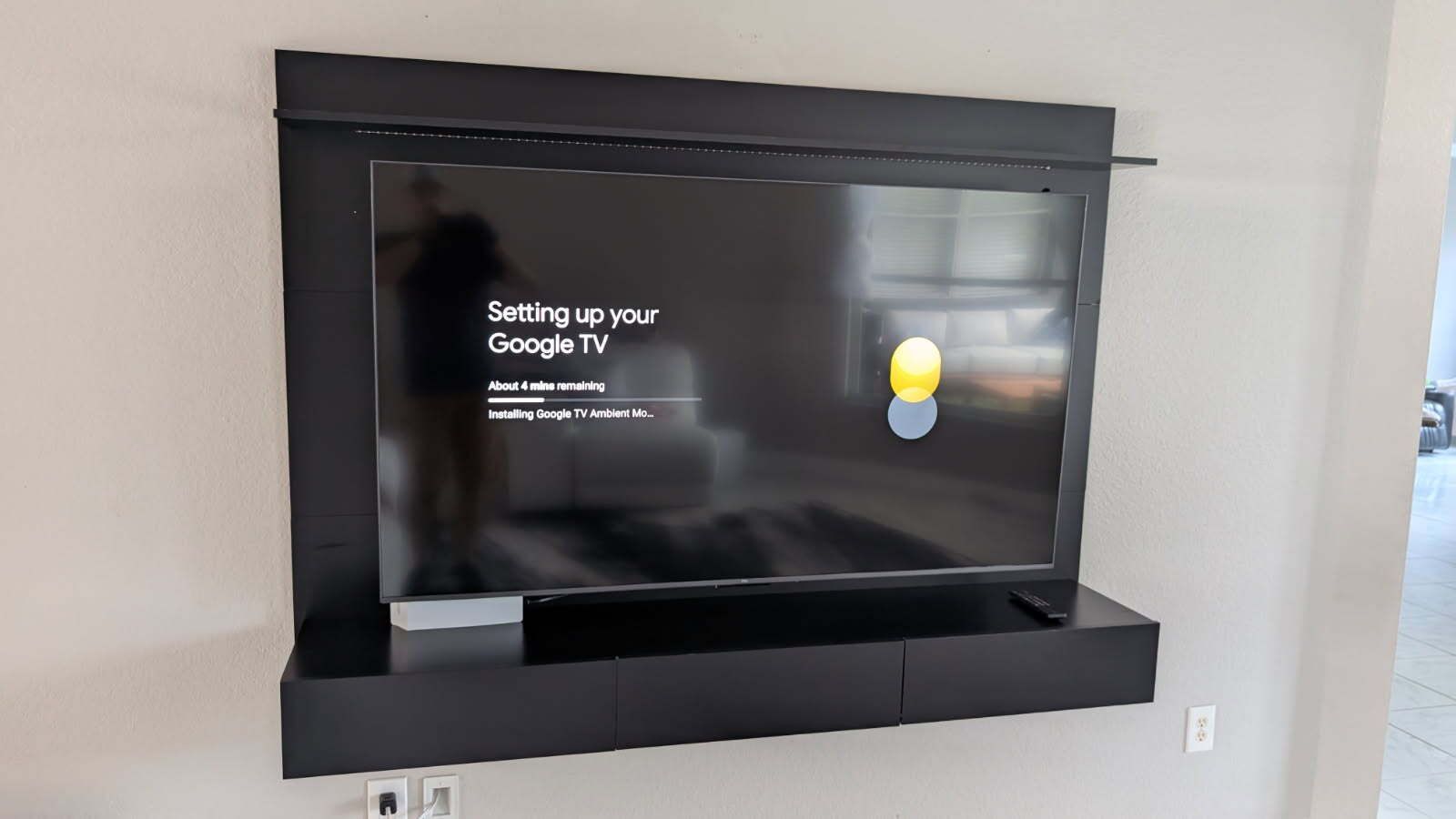 A flat screen tv is mounted on a wall in a living room.