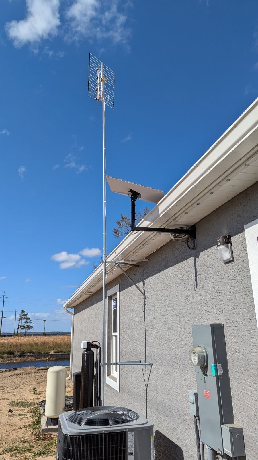 A house with a satellite dish on the side of it.