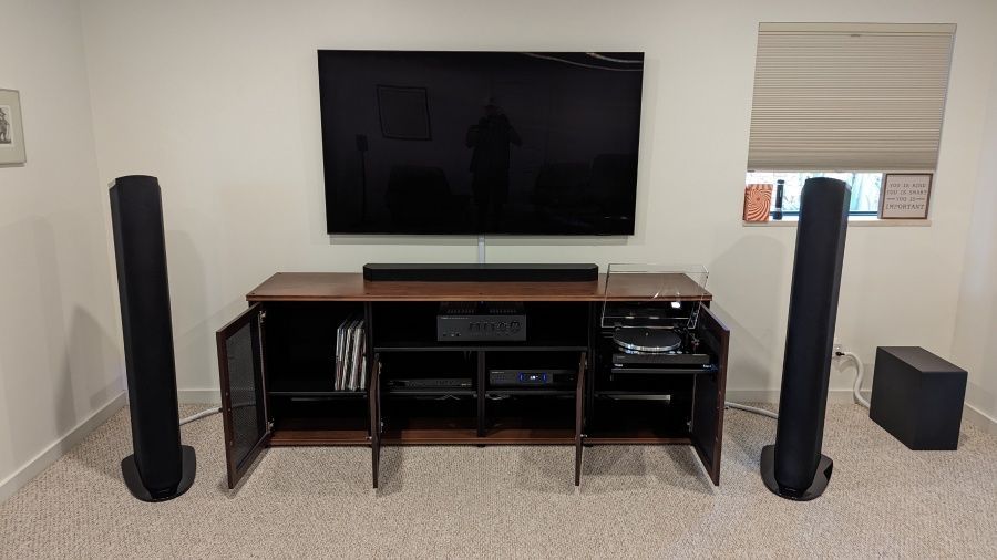 A living room with a flat screen tv and speakers