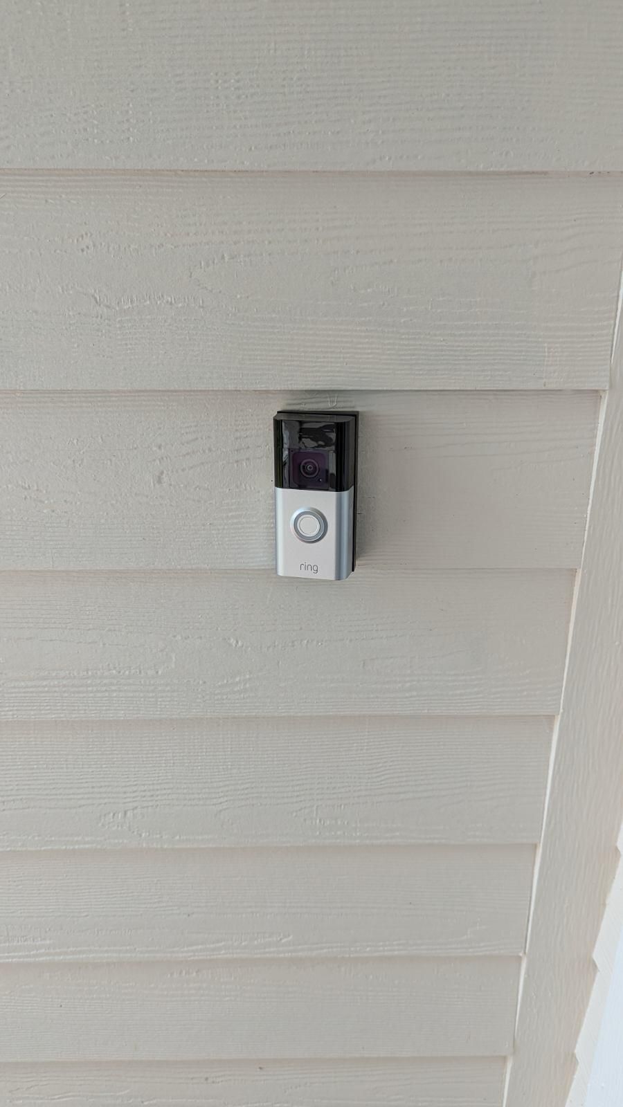 A doorbell is hanging from the ceiling of a house.