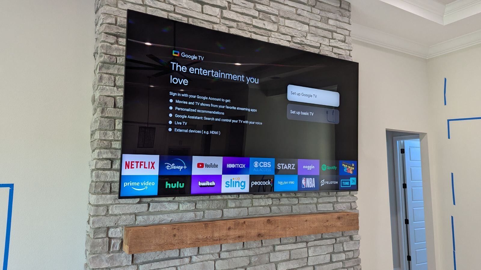 A flat screen tv is mounted on a brick wall.