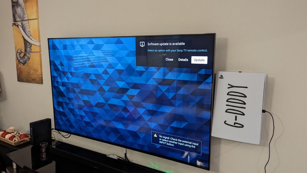 A large flat screen tv is hanging on a wall next to a sign that says g-buddy.