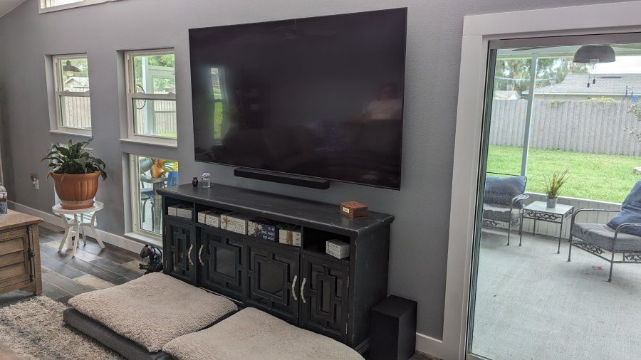 A living room with a large flat screen tv mounted on the wall.