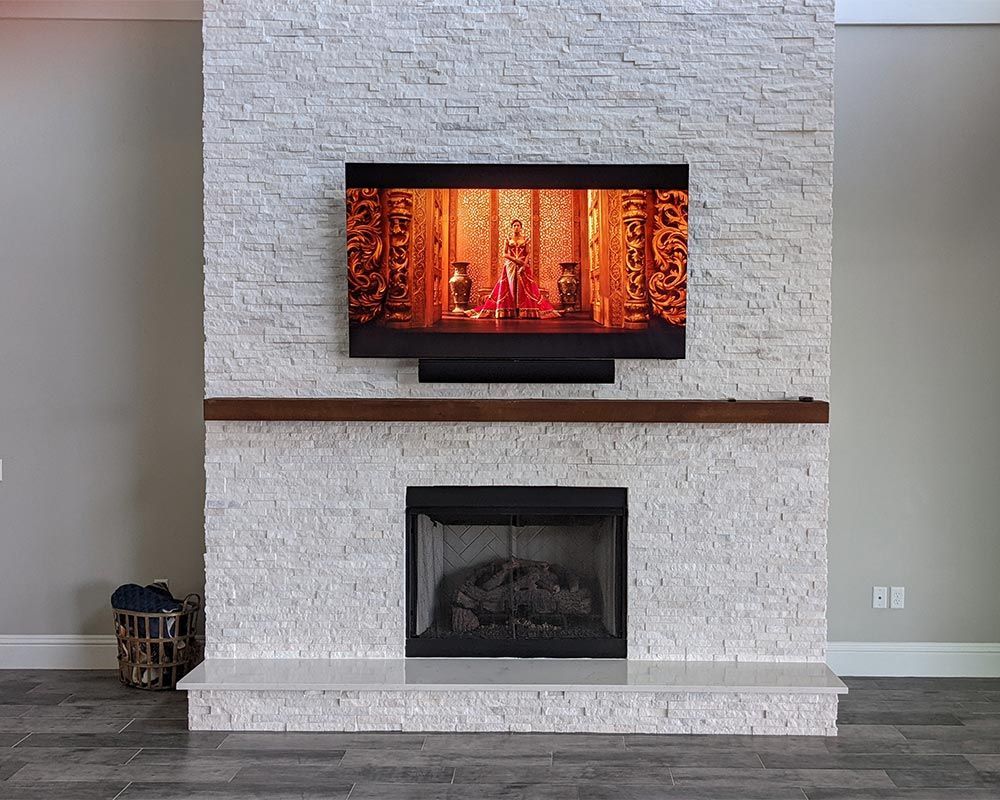 A fireplace with a flat screen tv above it