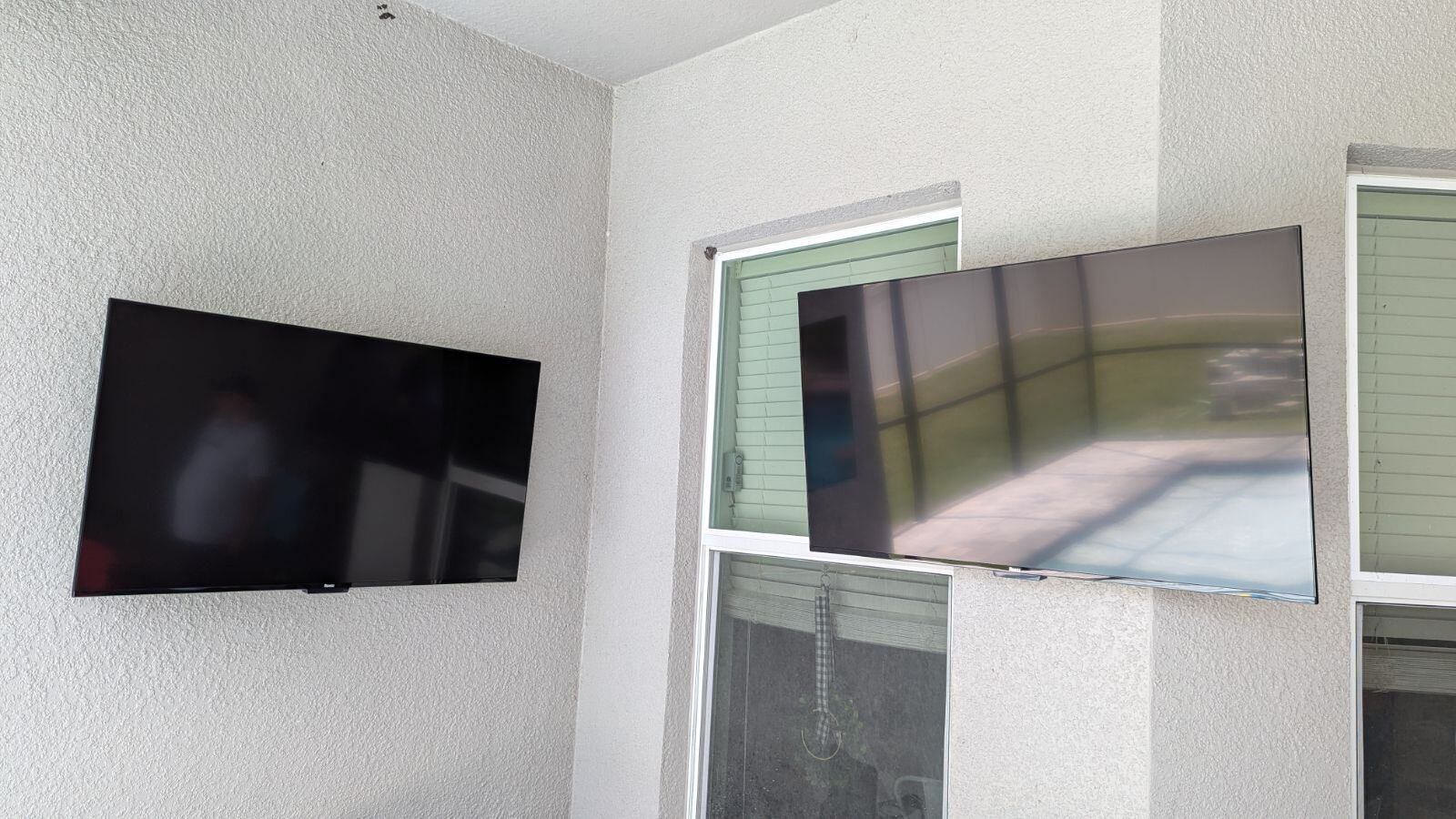 A flat screen tv is mounted on a wall above a entertainment center