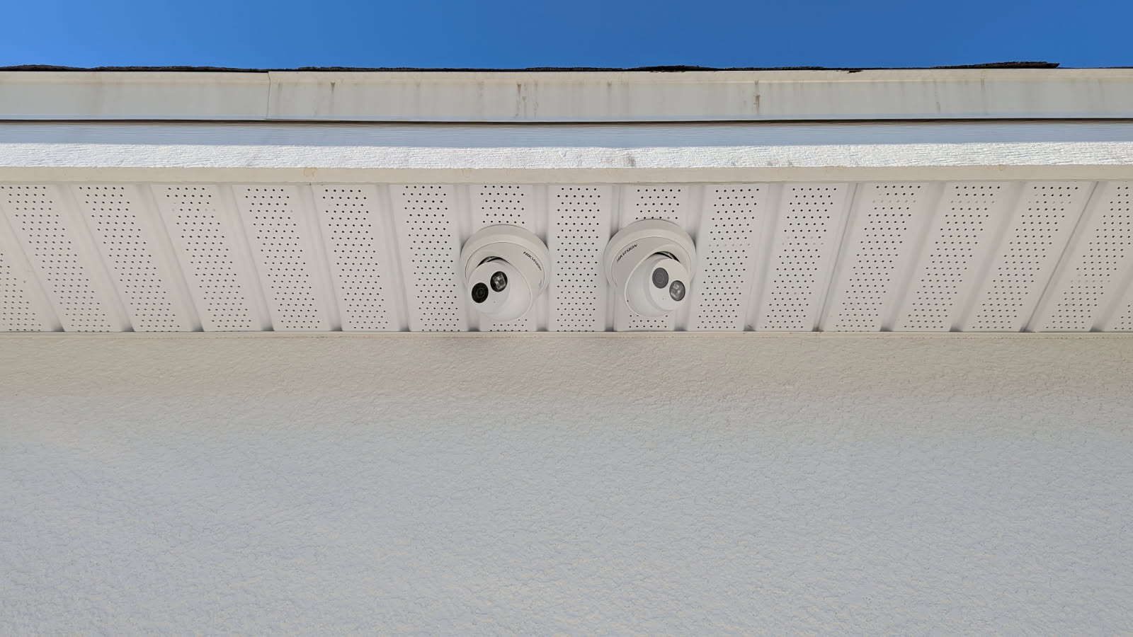A close up of a roof with a blue sky in the background.
