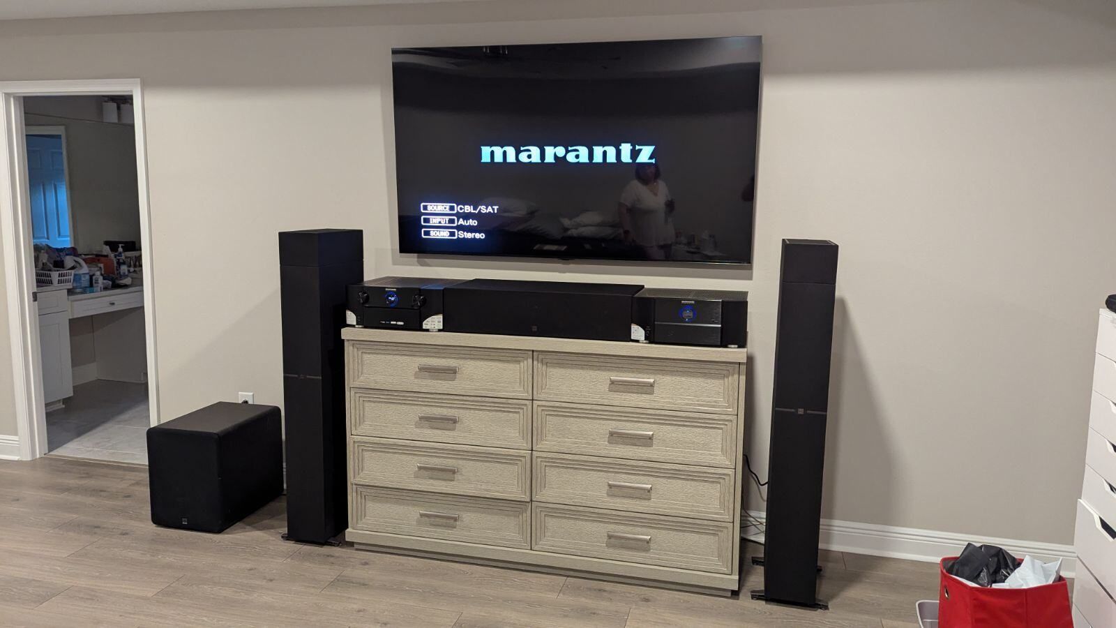 A marantz television is sitting on top of a dresser in a living room.