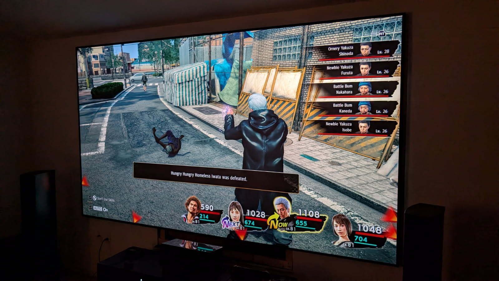 A video game is being played on a large flat screen tv.