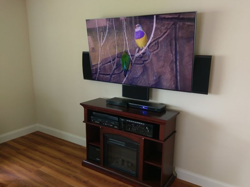 A living room with a fireplace and a flat screen tv