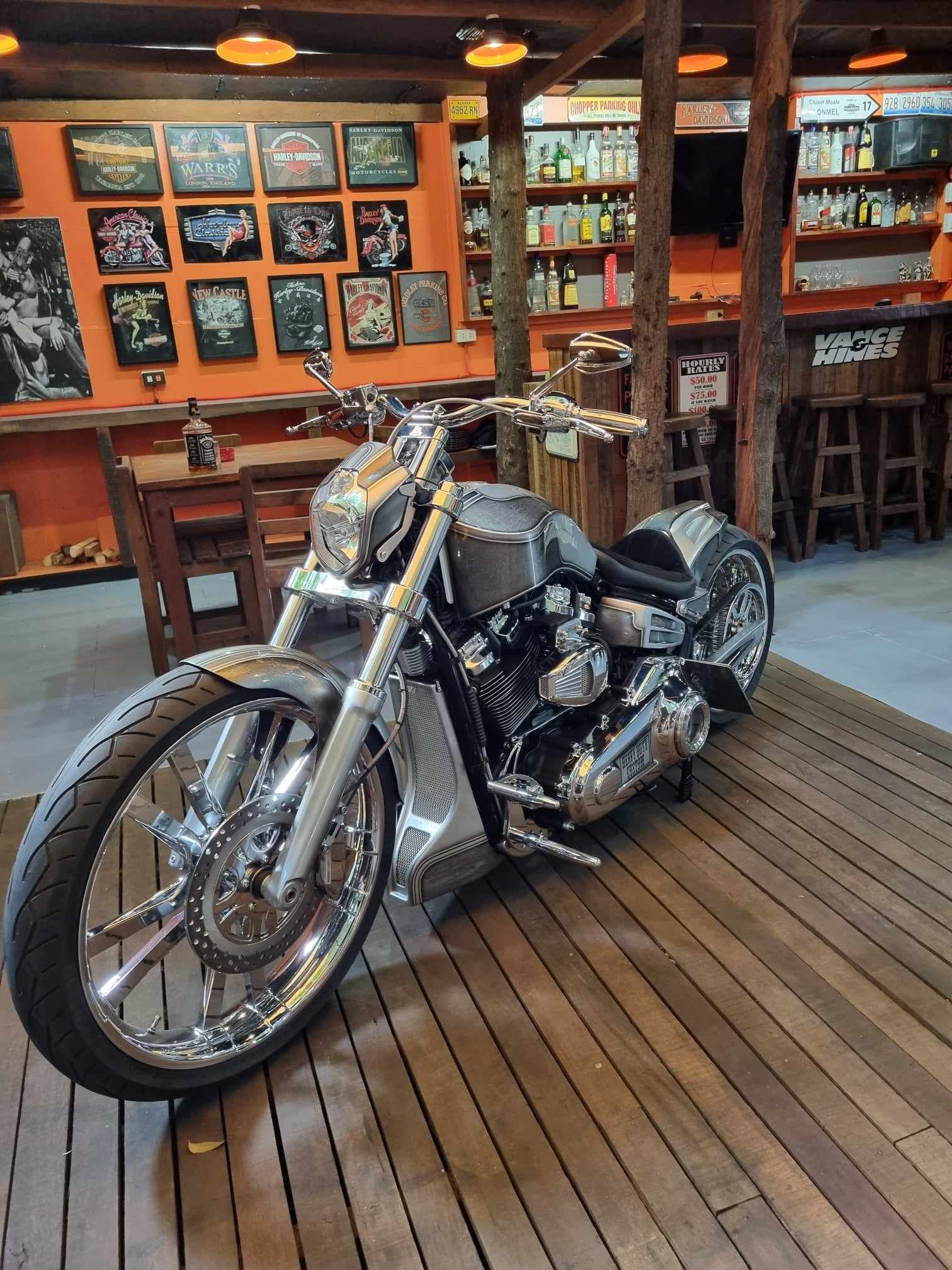 a row of motorcycles are parked on a wooden deck