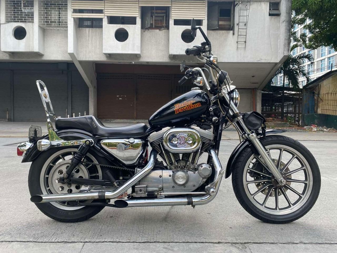 A harley davidson motorcycle is parked in front of a building.