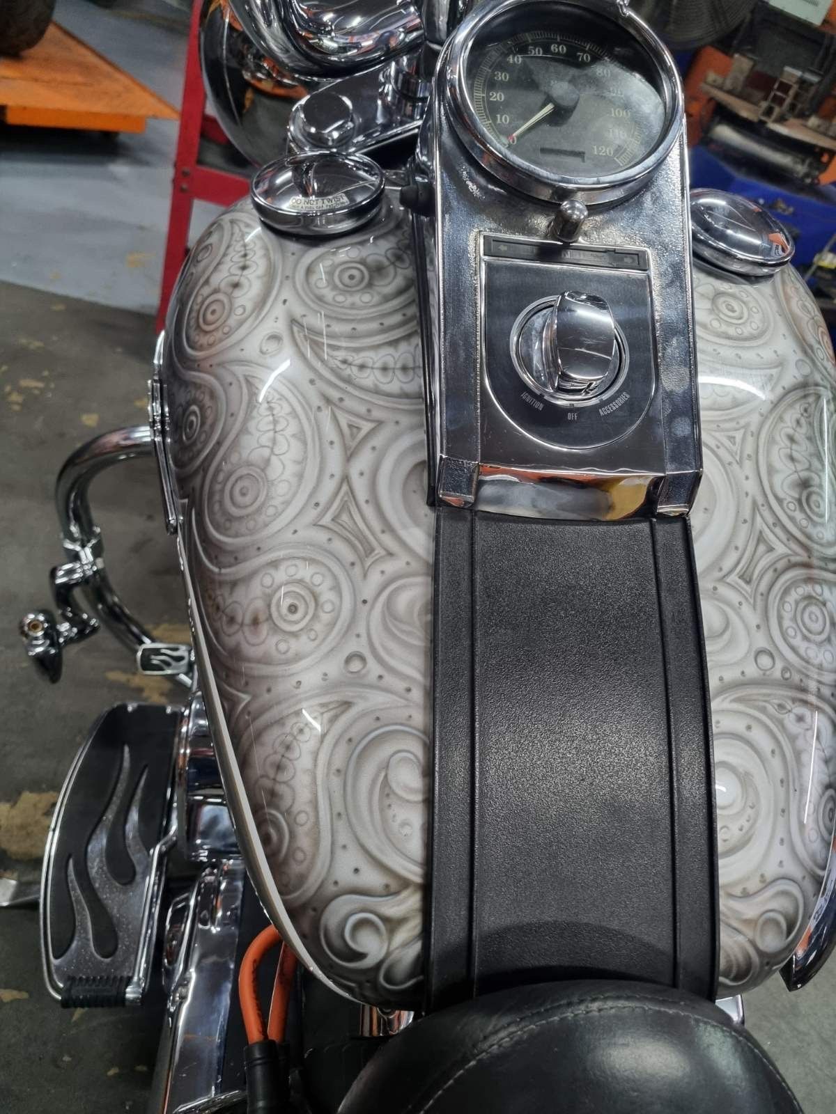 A harley davidson motorcycle with a paisley pattern on the tank