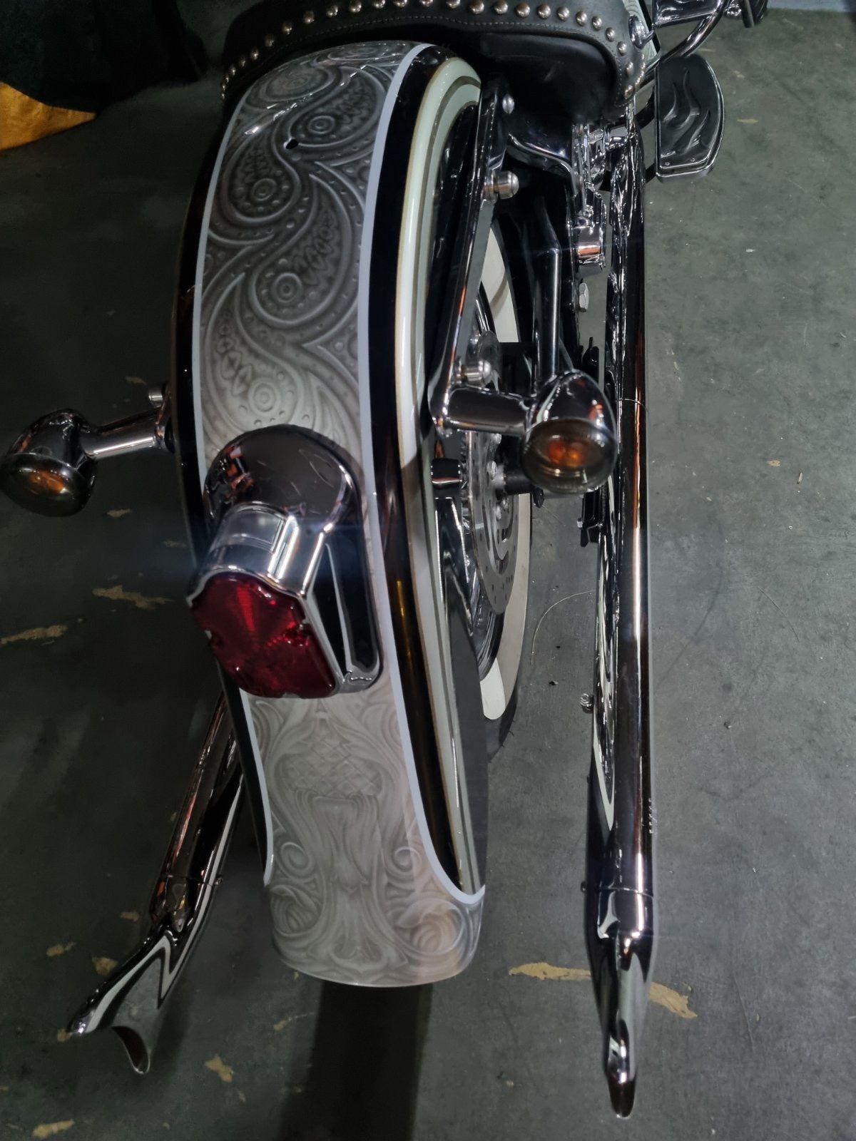 A close up of a motorcycle 's fender and tail light