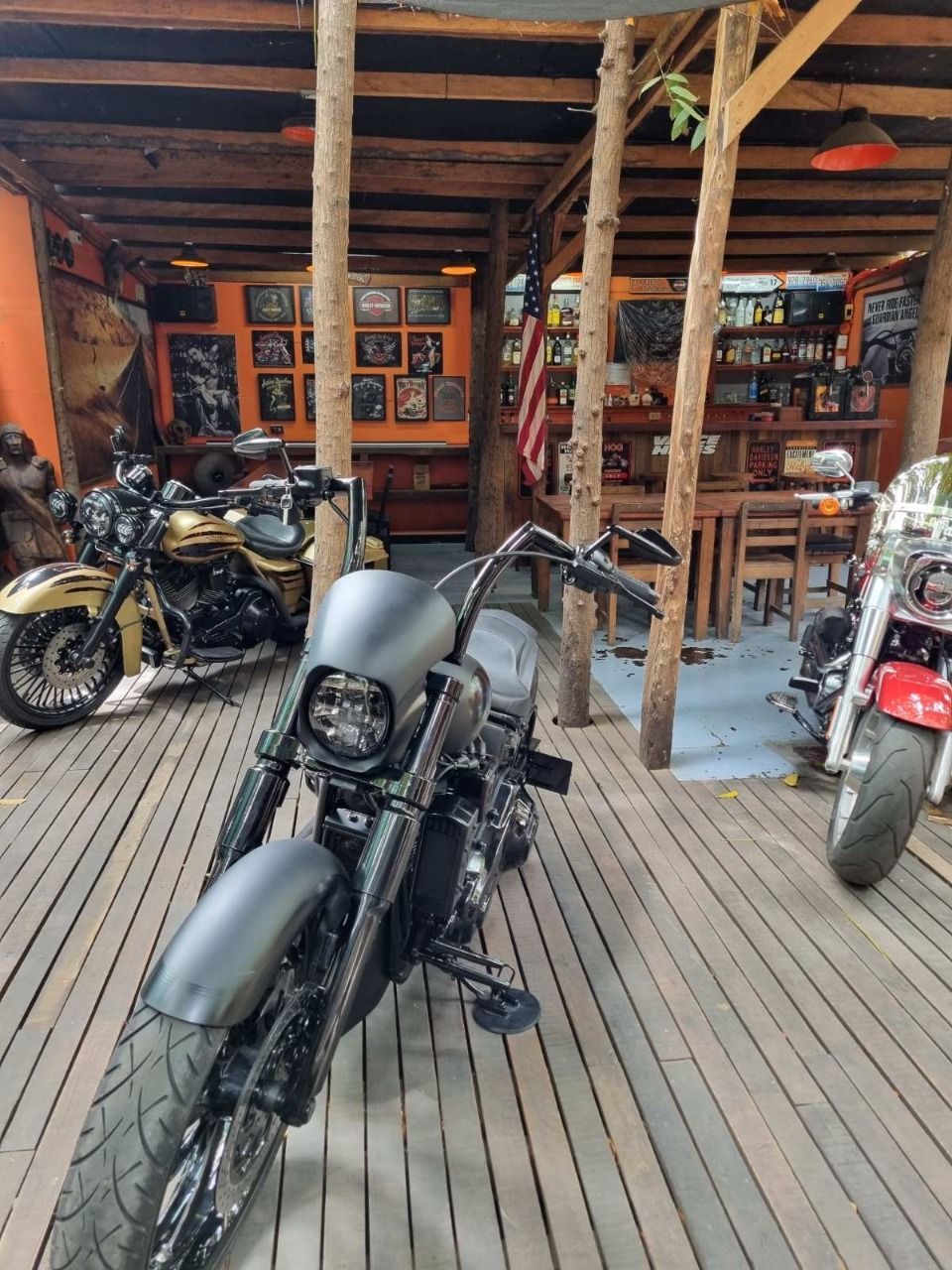 a row of motorcycles are parked on a wooden deck