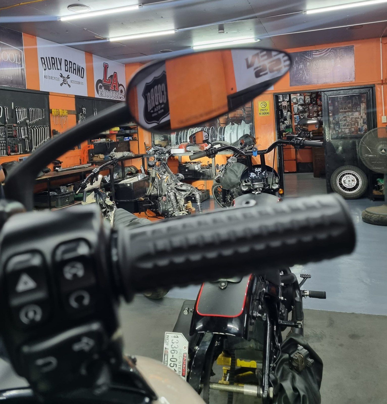 a motorcycle in a garage with a sign that says world famous