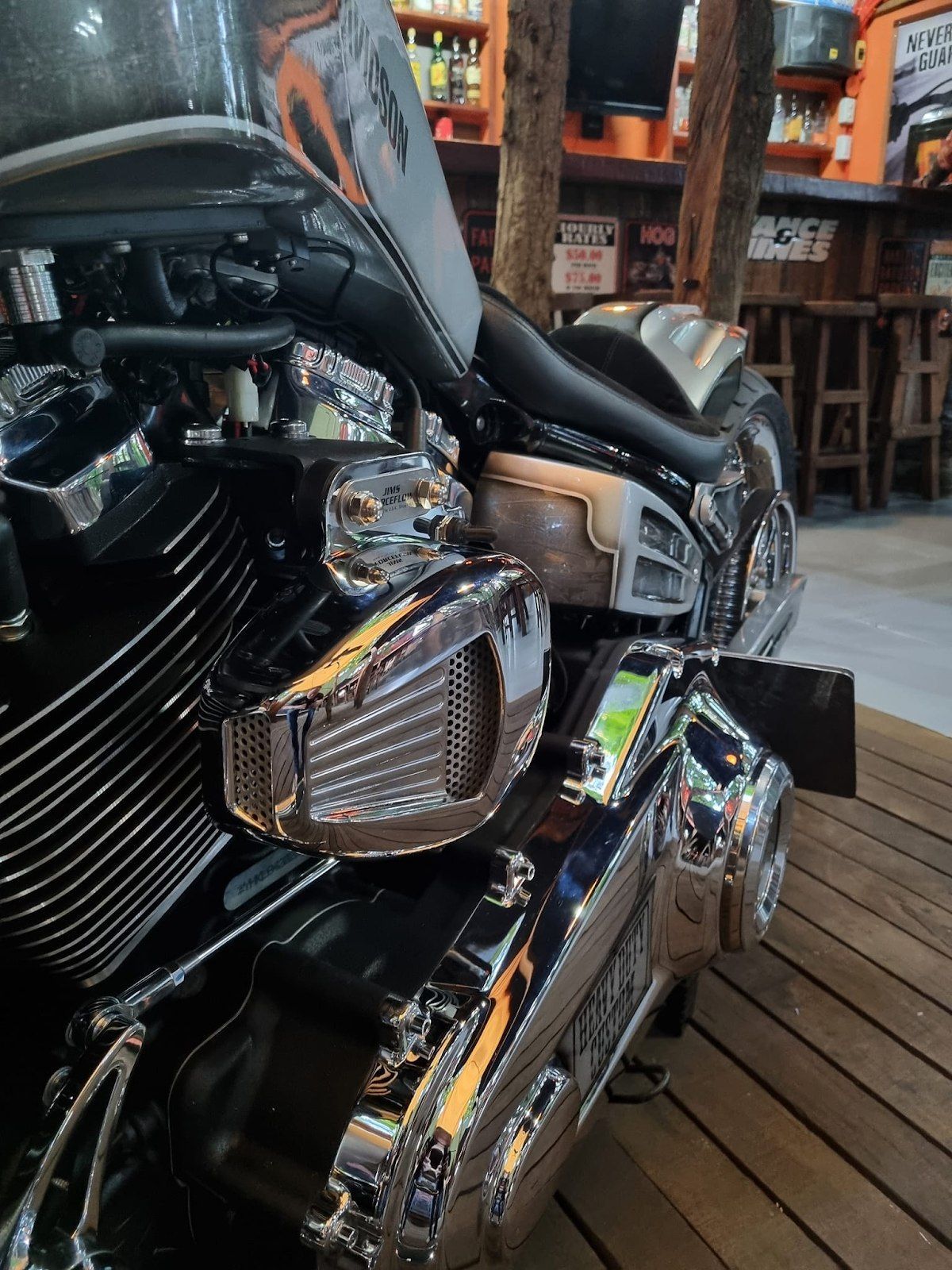 a harley davidson motorcycle is parked on a wooden deck .