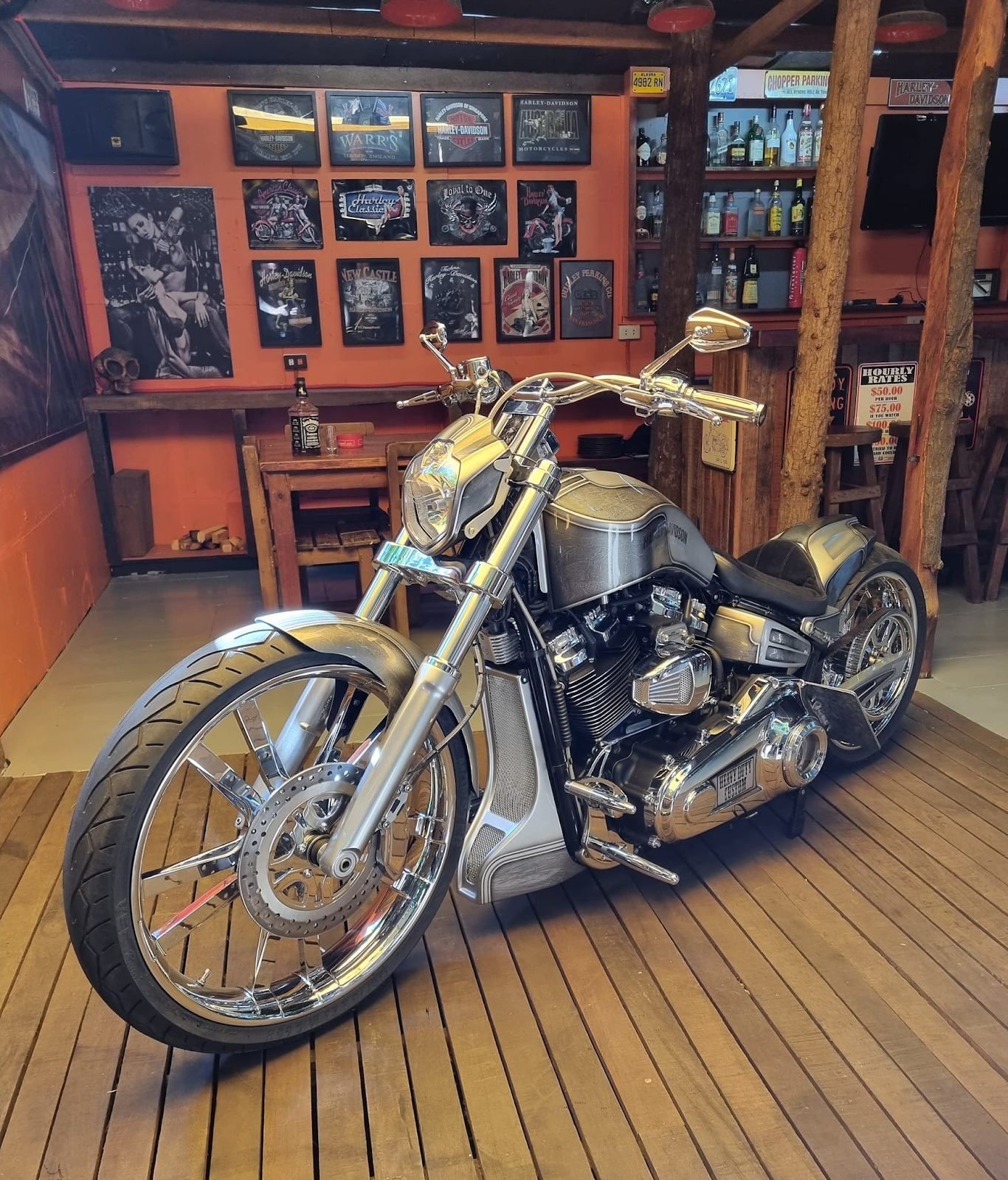 a motorcycle is parked on a wooden floor in a room .