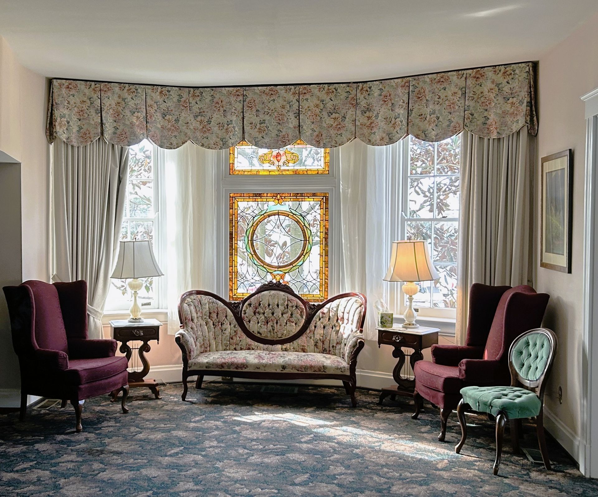 A large white house with a driveway leading to it.