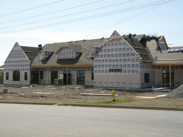 a building under construction with a fire hydrant in front of it