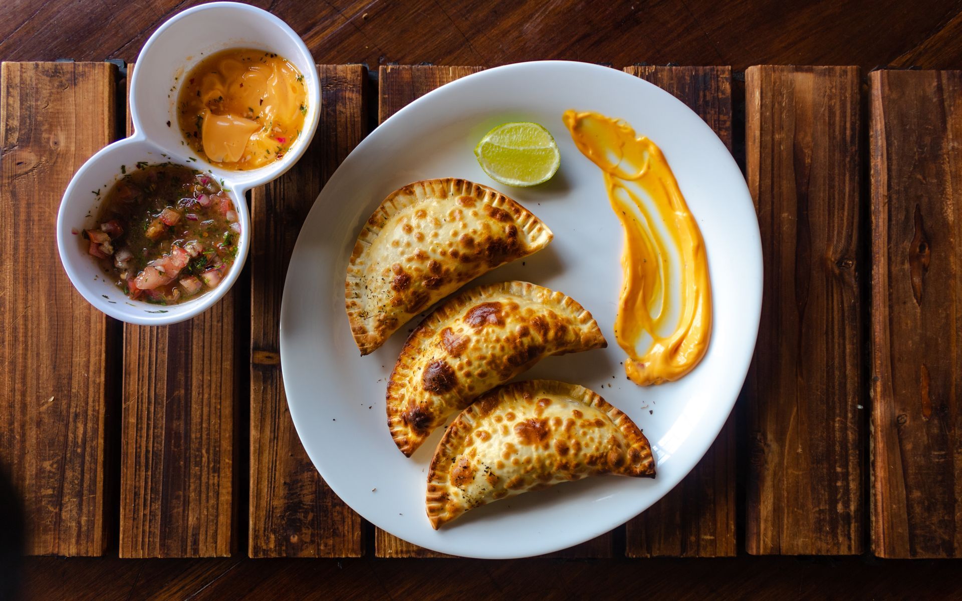 Chicken wings with dark glaze, arranged on a white plate with cilantro.