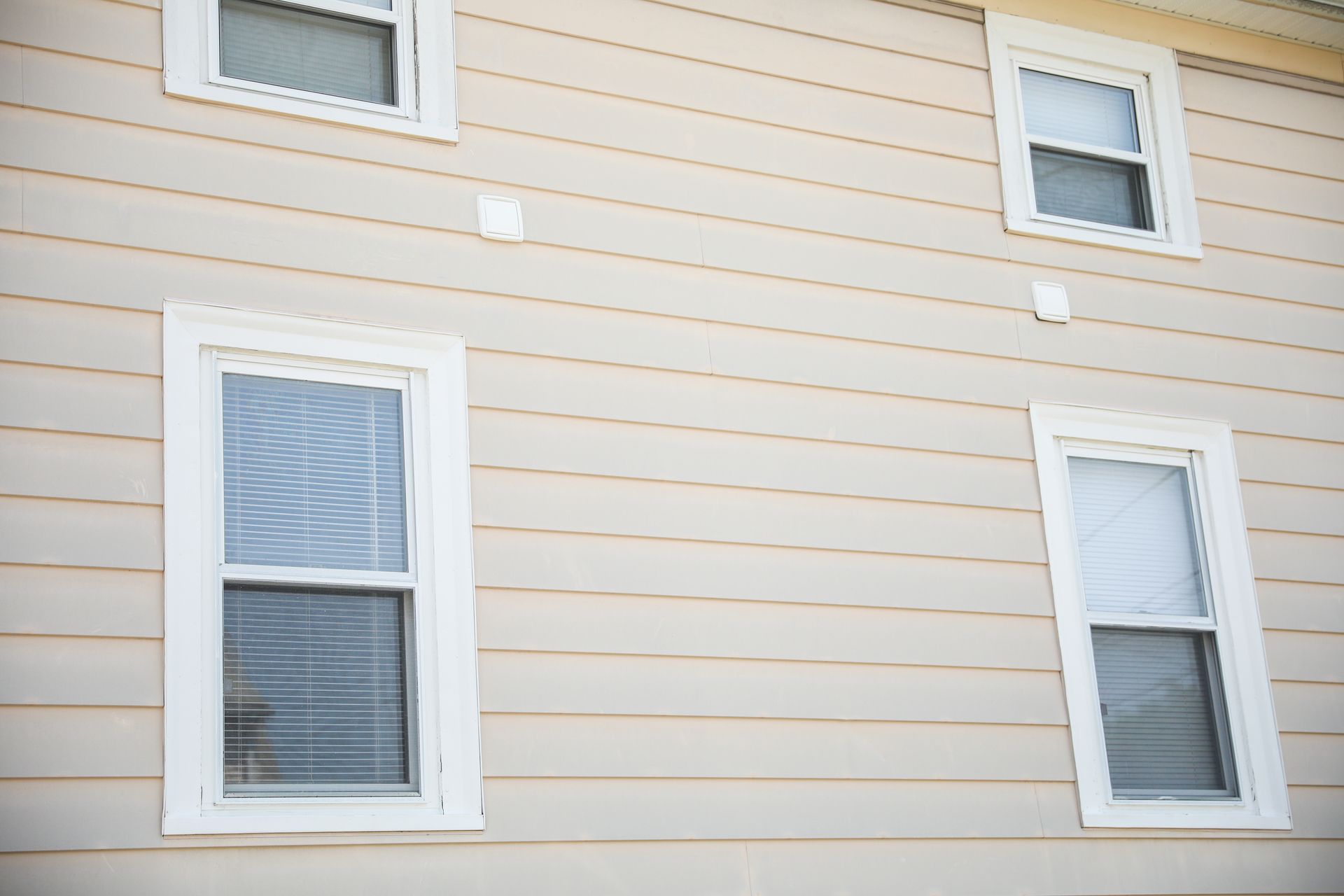 A house with three windows on the side of it