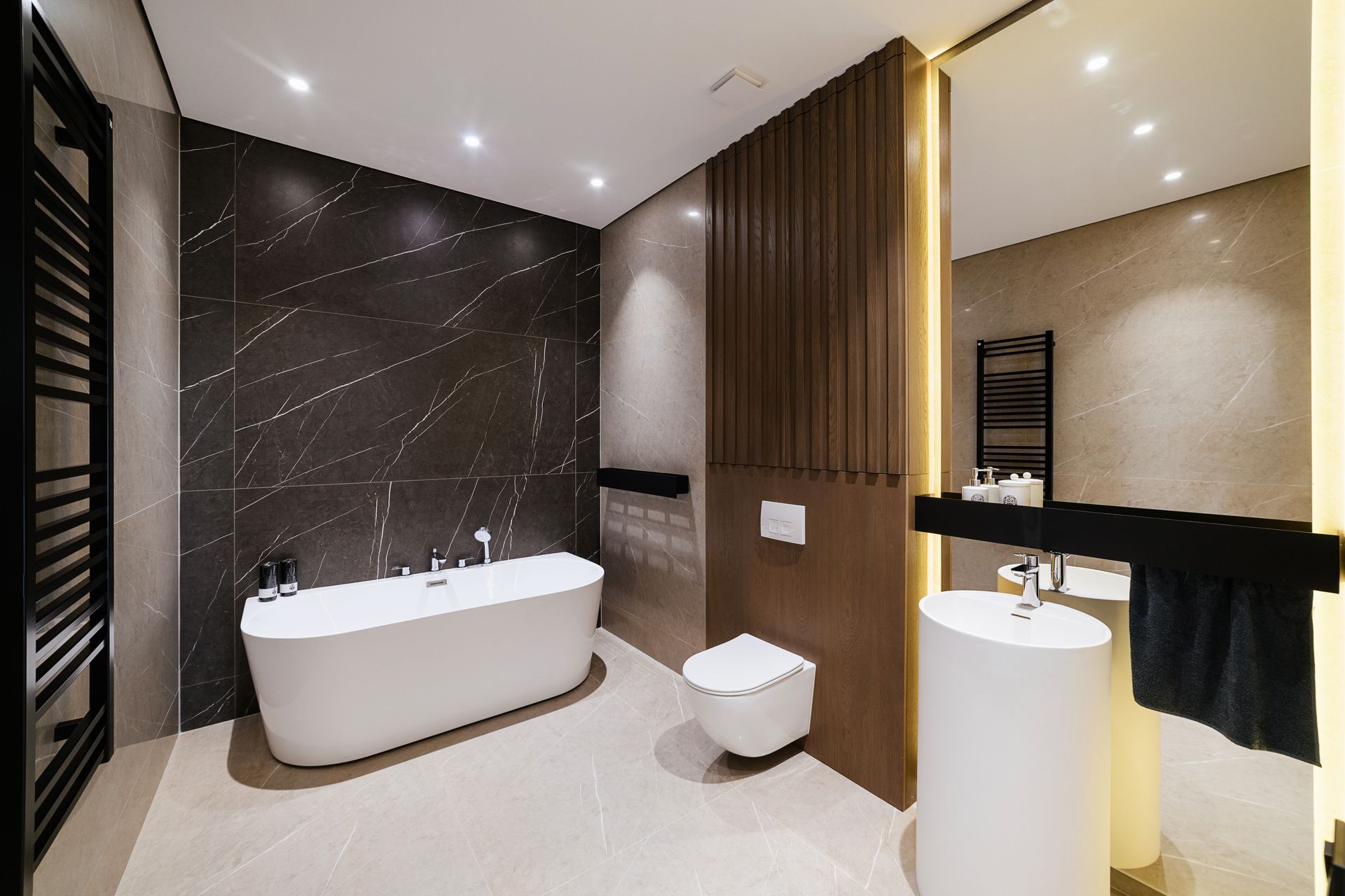 A bathroom with a bathtub , toilet , sink and mirror.