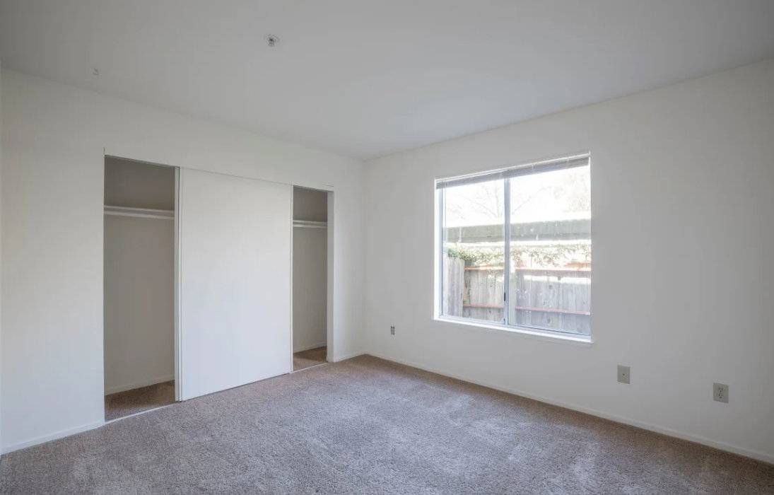Photo of a bedroom showing sliding door closets
