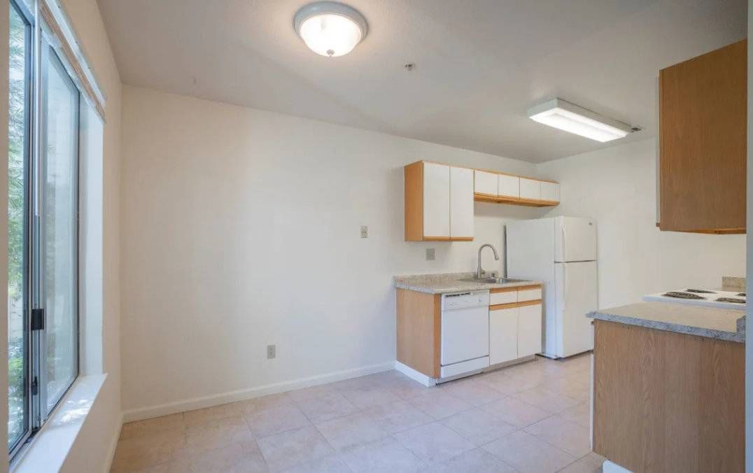 Photo of a dining area and a kitchen with plenty of space between the counters