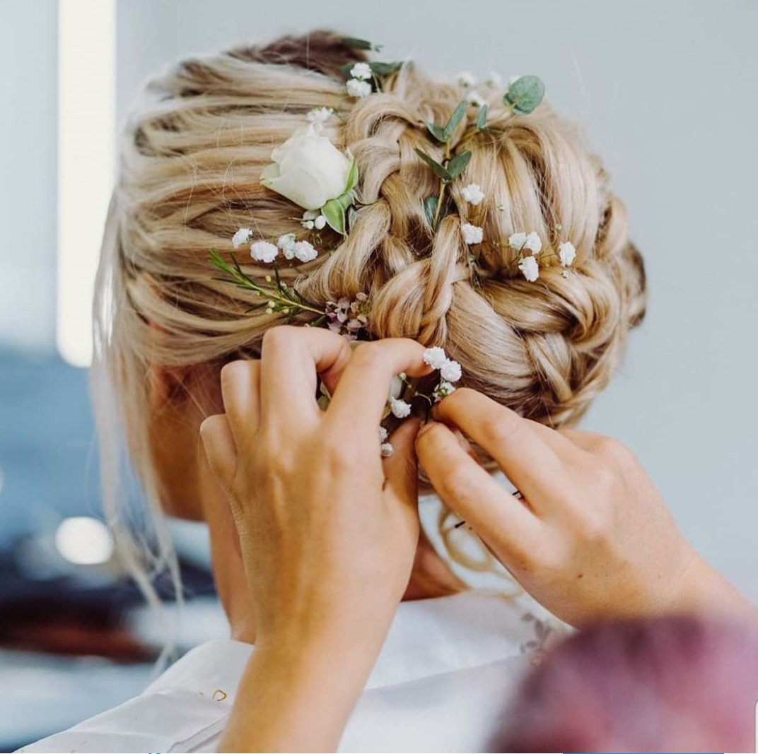 hair up with braids, roses, eucalyptus and rosemary in hair